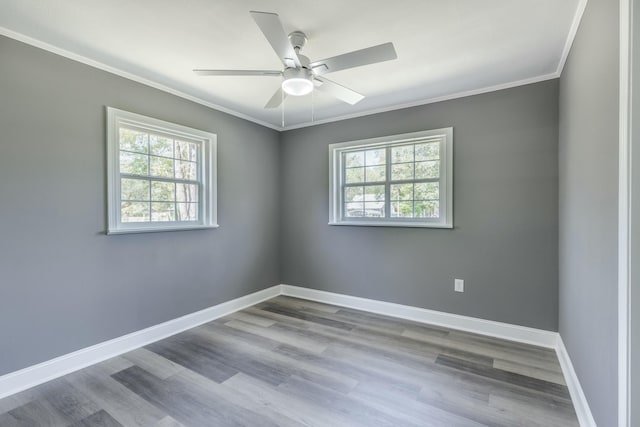 unfurnished room with crown molding, a healthy amount of sunlight, and baseboards