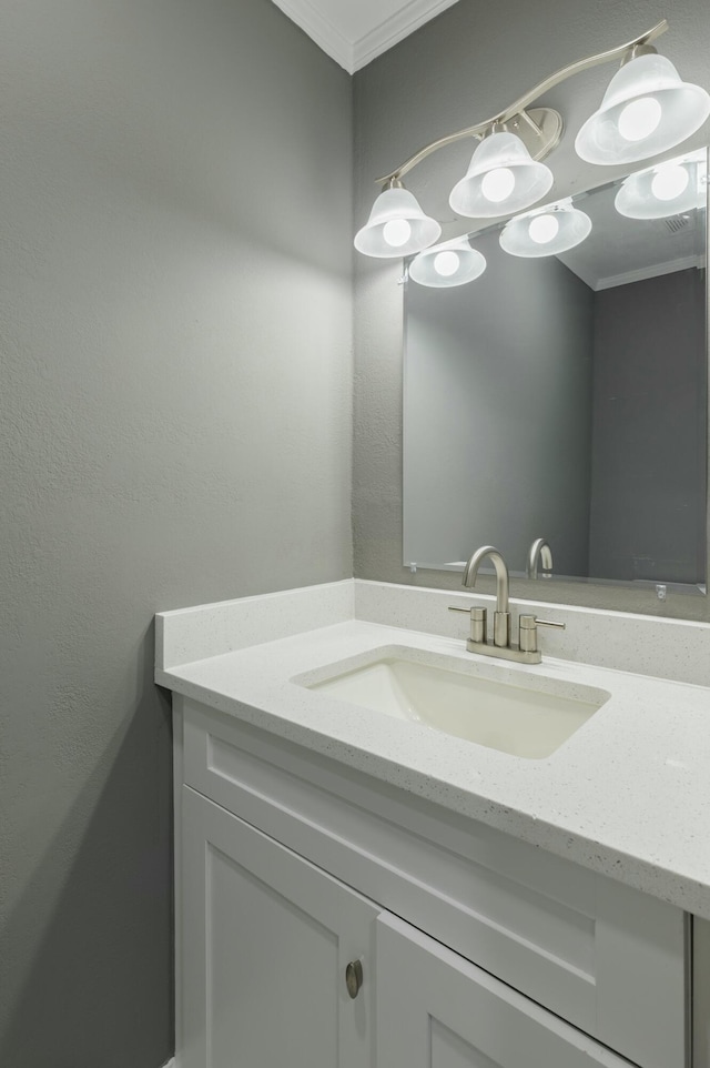 bathroom featuring vanity and ornamental molding