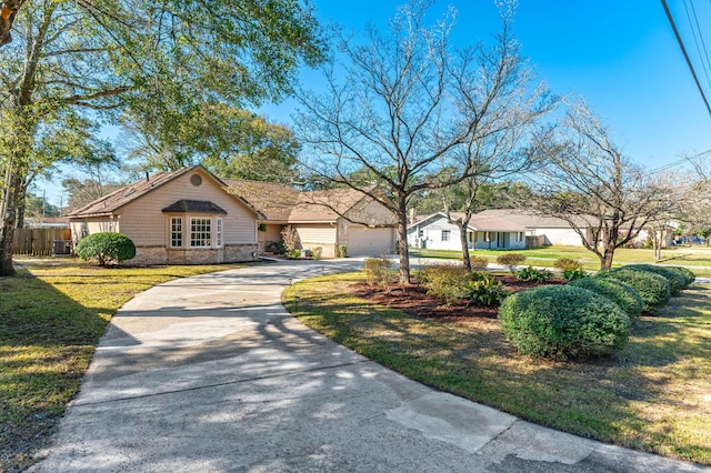 single story home featuring brick siding, concrete driveway, a front lawn, and fence