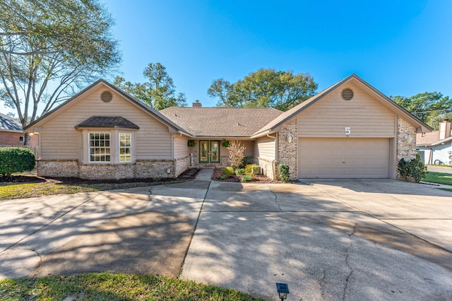 view of front of house featuring concrete driveway, a garage, brick siding, and a chimney