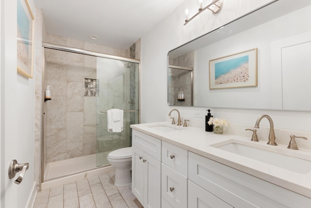 full bathroom with a sink, toilet, and a shower stall