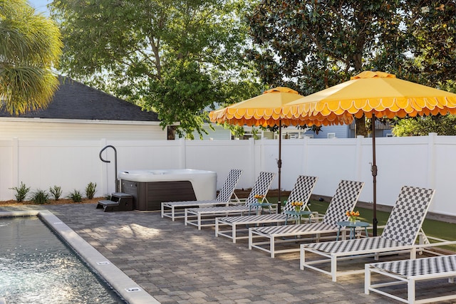 view of patio with a fenced backyard and a hot tub