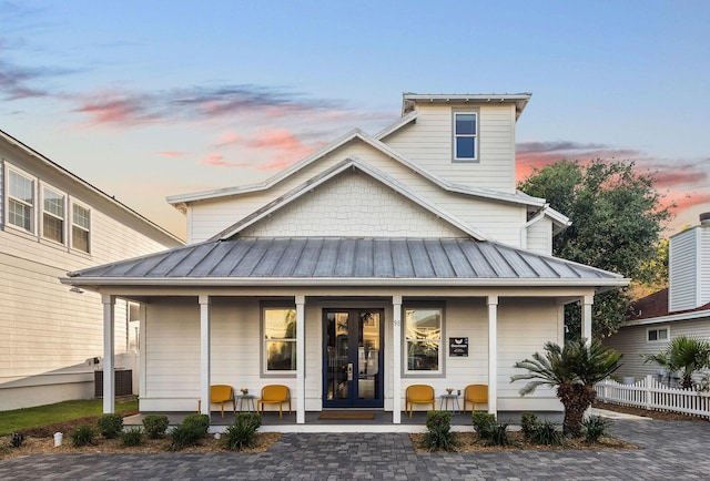 view of front of home featuring metal roof, french doors, and a standing seam roof