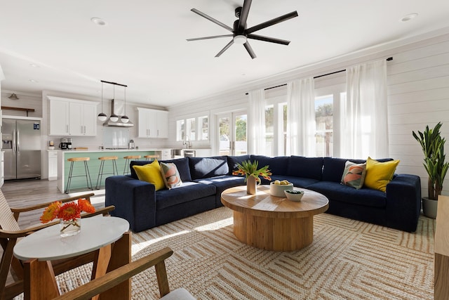 living room with recessed lighting, wooden walls, and ceiling fan