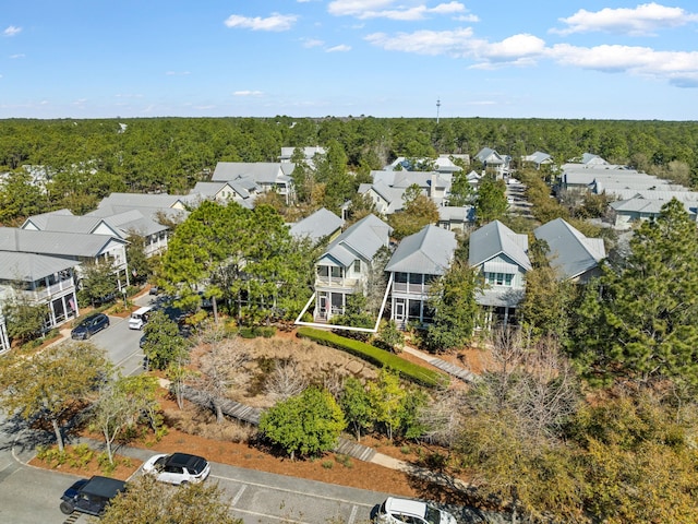 birds eye view of property with a residential view and a wooded view