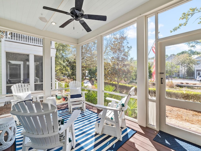 sunroom / solarium featuring ceiling fan