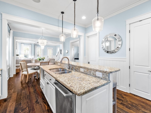 kitchen featuring a sink, dishwasher, an island with sink, and white cabinets