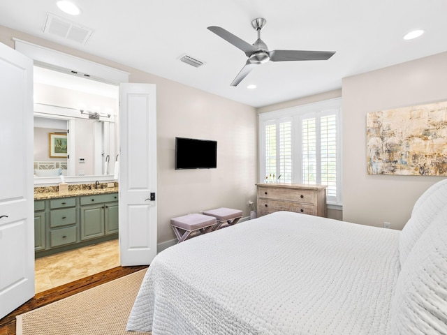 bedroom featuring recessed lighting, visible vents, wood finished floors, and connected bathroom