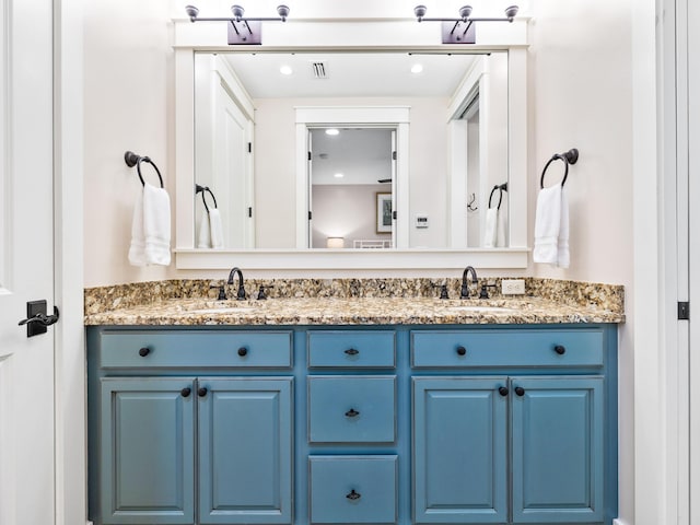 full bathroom featuring a sink, visible vents, and double vanity