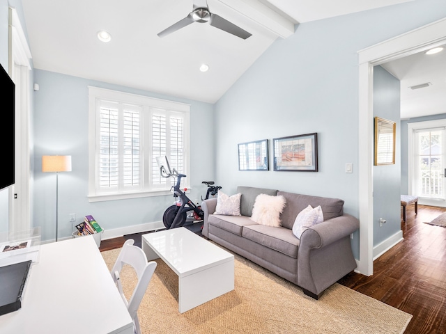 living area with a ceiling fan, lofted ceiling with beams, wood finished floors, and baseboards