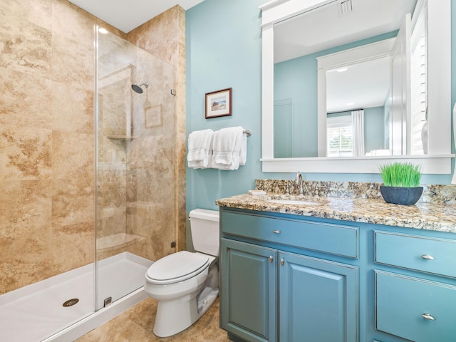 bathroom featuring vanity, a shower stall, toilet, and visible vents