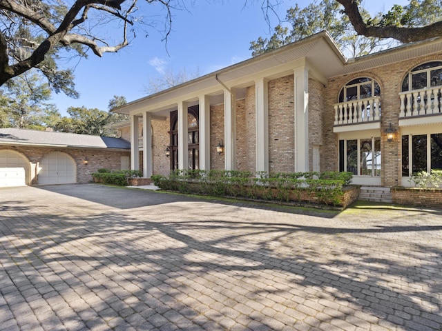 exterior space featuring brick siding and a garage