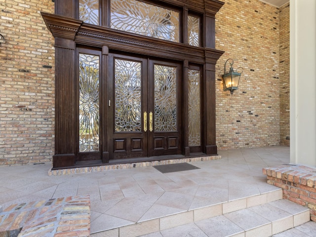 property entrance with french doors and brick siding