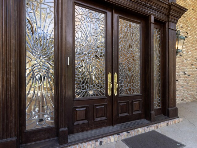 doorway to property with french doors and brick siding