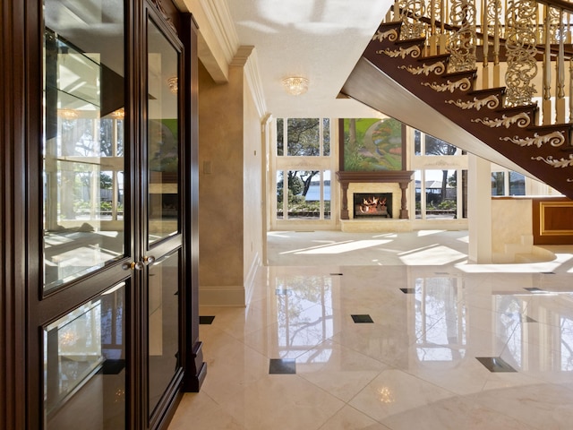 foyer with crown molding, wine cooler, baseboards, and a premium fireplace