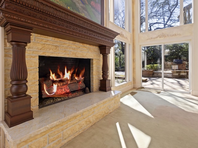 room details with a stone fireplace and carpet