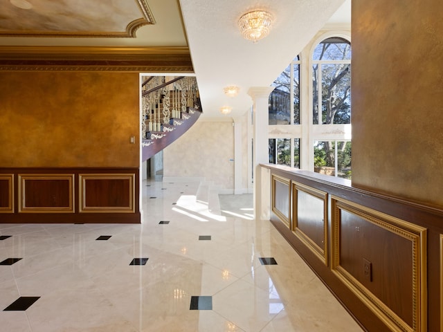 bathroom with marble finish floor, ornamental molding, and ornate columns