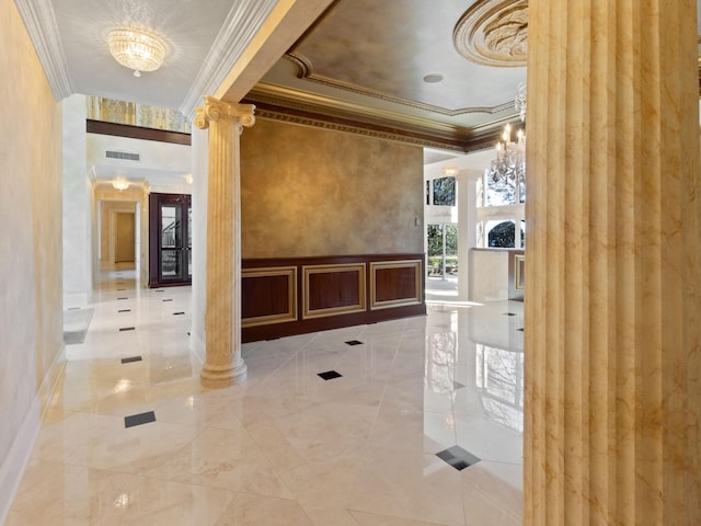 welcome area with an inviting chandelier, visible vents, and ornate columns