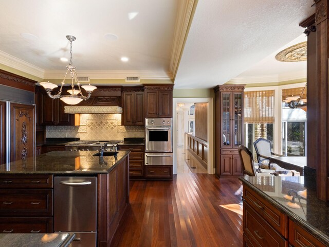 kitchen featuring crown molding, a warming drawer, dark wood-type flooring, and stainless steel oven