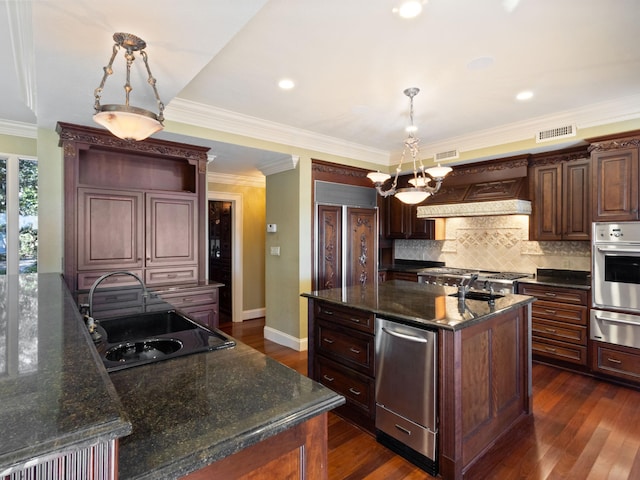 kitchen featuring custom exhaust hood, an island with sink, a sink, stainless steel oven, and a warming drawer