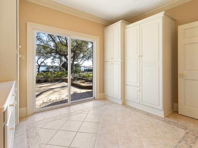 interior space featuring crown molding, access to outside, light tile patterned flooring, and baseboards