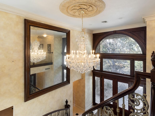 stairway with visible vents, a chandelier, and crown molding