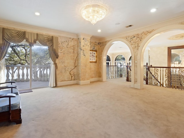 interior space featuring visible vents, carpet floors, crown molding, an upstairs landing, and a chandelier