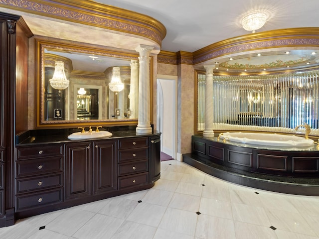 full bath featuring a bath, vanity, ornate columns, and ornamental molding