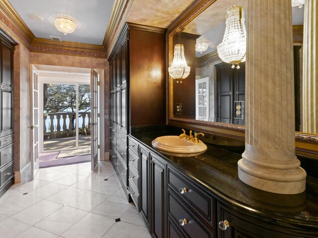 bathroom with vanity, visible vents, ornamental molding, tile patterned floors, and a chandelier