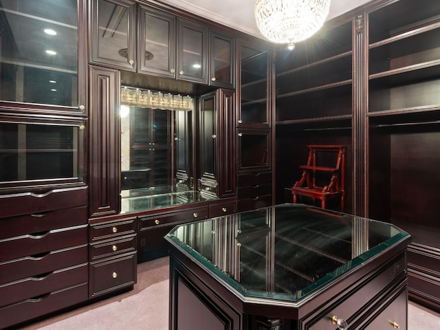 spacious closet featuring light colored carpet and a chandelier