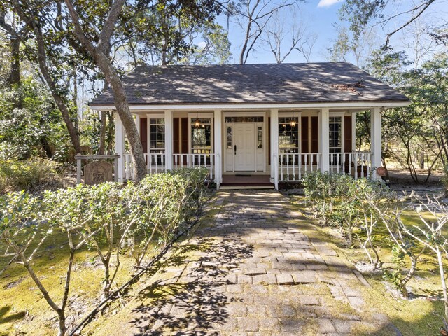 view of front of home featuring a porch and a shingled roof