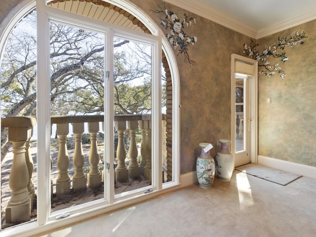 doorway to outside featuring carpet flooring, baseboards, and ornamental molding