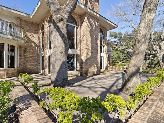 view of side of property featuring brick siding