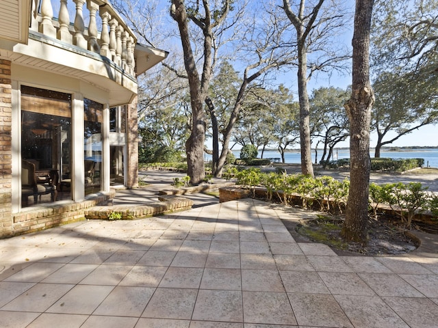 view of patio with a water view