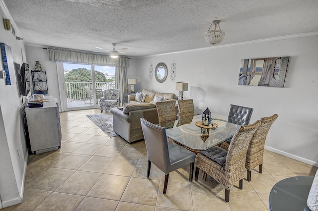 dining space featuring a textured ceiling, tile patterned floors, and ornamental molding