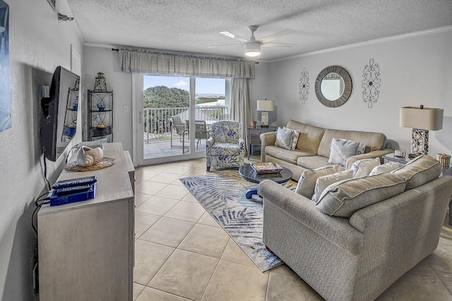 living area featuring a textured ceiling, light tile patterned flooring, and ornamental molding