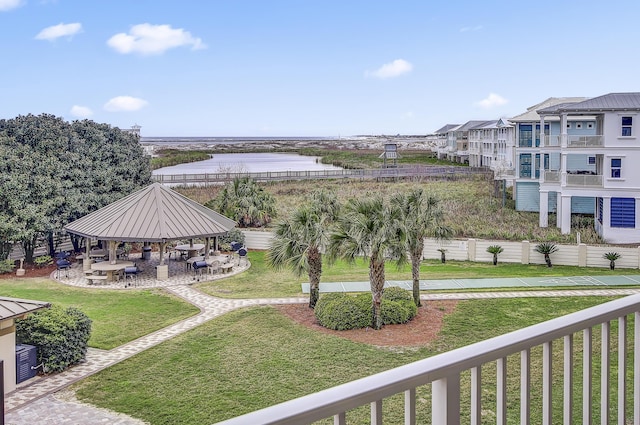 exterior space featuring a gazebo, a yard, and a water view