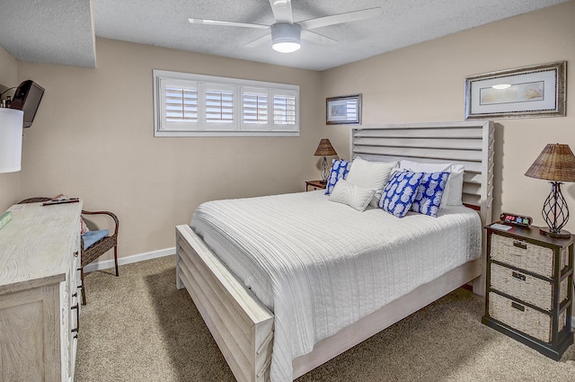 carpeted bedroom featuring baseboards, a textured ceiling, and a ceiling fan