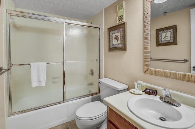 full bath featuring visible vents, toilet, a textured ceiling, bath / shower combo with glass door, and vanity