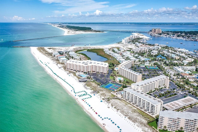 drone / aerial view with a water view, a city view, and a beach view