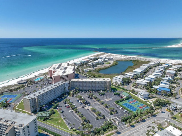 drone / aerial view featuring a beach view and a water view