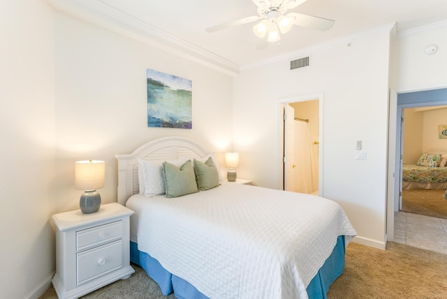 bedroom featuring visible vents, light carpet, crown molding, baseboards, and ceiling fan