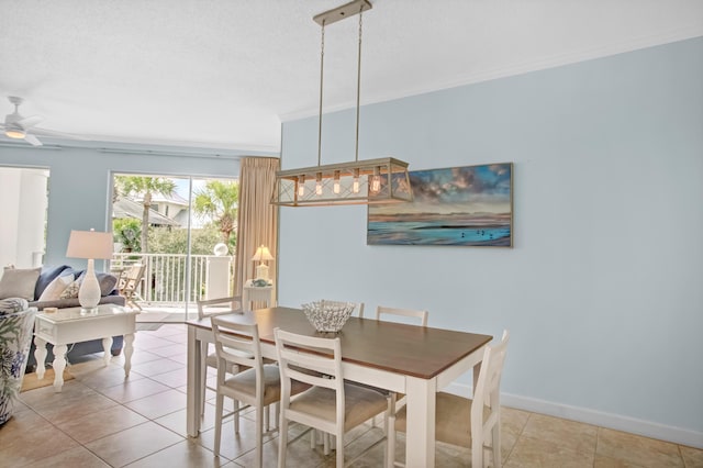 dining area featuring light tile patterned floors, baseboards, and ornamental molding