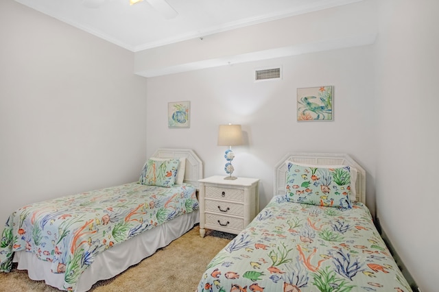 bedroom with visible vents, light carpet, ornamental molding, and a ceiling fan