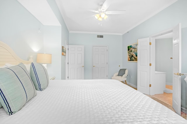 bedroom featuring tile patterned flooring, visible vents, baseboards, ornamental molding, and a ceiling fan