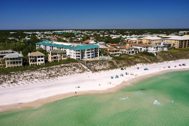 drone / aerial view featuring a water view and a beach view