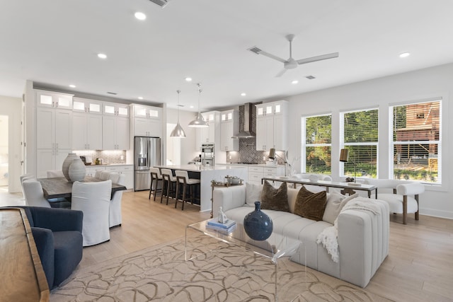 living area with visible vents, recessed lighting, light wood-style floors, and ceiling fan