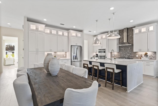 dining room featuring recessed lighting, visible vents, and light wood finished floors