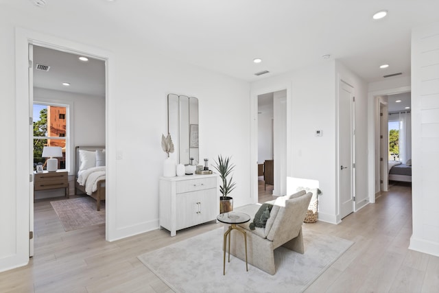 living area featuring recessed lighting, visible vents, and light wood-type flooring