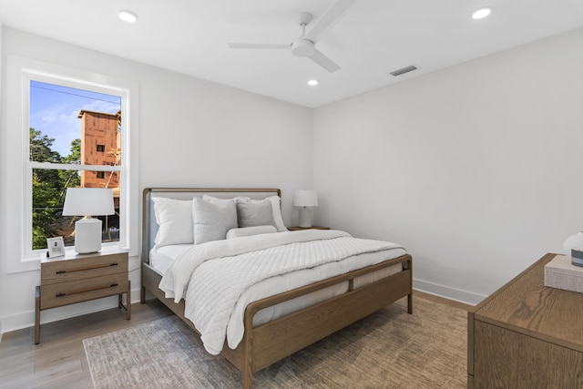 bedroom with light wood-type flooring, visible vents, baseboards, and recessed lighting